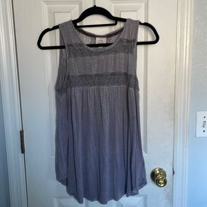 a grayish tank top with a lace design on both front and back